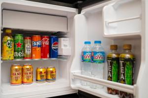 an open refrigerator filled with bottles of soda and drinks at Grand Hotel Vinh Yen in Vĩnh Phúc
