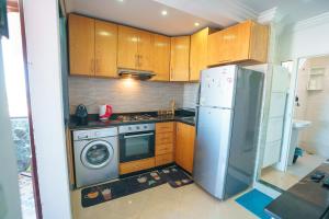 una cocina con nevera y lavadora en Ocean Vibes Sea View and Fast Wi-Fi, en Tánger 8 fotos más