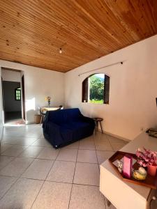 a living room with a blue couch and a wooden ceiling at House in sana in Sana