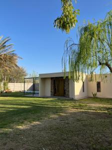 a small white building with a large yard at Casa ullum in San Juan