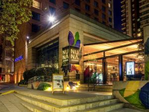 a store front of a building at night at Novotel Santiago Las Condes in Santiago