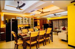 a kitchen and living room with a table and chairs at Luxurious Apartment at city heart near Airport in Bāiljuri