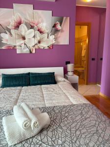 a bedroom with a large bed with purple walls at Skyline 15 Milano - Panoramic Apartment and Free Parking in Milan