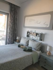 a bedroom with a bed with a sign that says love at Nisteri Seaside in Limenas