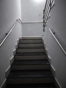 a stairway with a set of stairs in a building at H M G service apartment in Sringeri