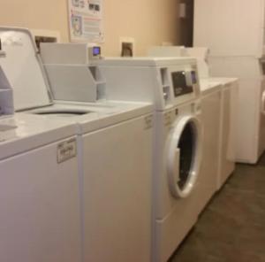 a white washer and dryer in a room at Stay Lodge of Thomasville in Thomasville