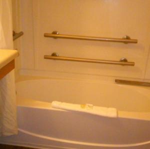 a bath tub in a bathroom with two towels on it at Stay Lodge of Thomasville in Thomasville