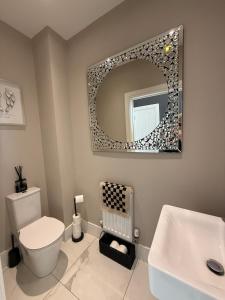 Un baño con un inodoro blanco y un espejo. en Luxury Wynyard Home, en Grindon 14 fotos más