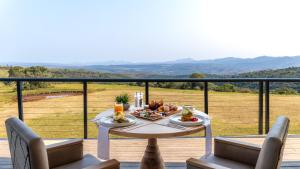 a table with fruit on it on a balcony at Intle Boutique Hotel in Jeffreys Bay