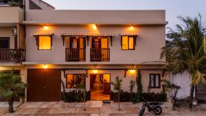 a white house with orange lights on it at Vila Dádiva Jeri in Jericoacoara