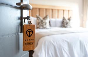 a wooden tag hanging from a door in a bedroom at Intle Boutique Hotel in Jeffreys Bay +82 photos