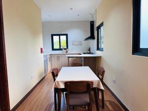 a kitchen with a table and chairs in a room at Sren Self Catering - One Bedroom II in Anse Royale