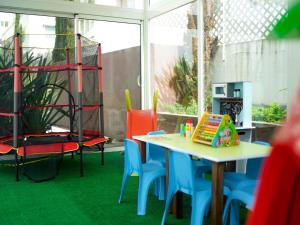 a room with a table and chairs and a room with green carpet at Aparthotel Adagio Premium Casablanca City Center in Casablanca