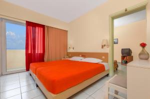 a bedroom with a bed and a large window at Pavlos Hotel in Kos Town