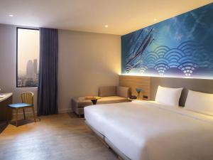 Ένα ή περισσότερα κρεβάτια σε δωμάτιο στο ibis Styles Bangkok Ratchada
