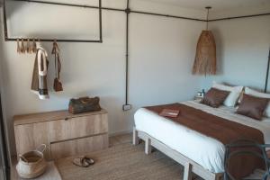 a bedroom with a bed and a wooden dresser at Bodegas y Viñedos Balcarce in Balcarce
