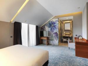 a hotel room with a bed and a desk and a television at Ibis Styles Istanbul Atasehir in Istanbul +46 photos