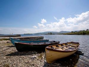 three boats sitting on the shore of a lake at 4 Bed in Clonbur oc-ii16388 in Clonbur