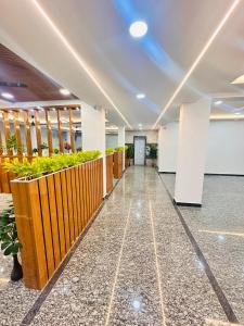 a hallway of an office building with plants at Hotel Aurora Bliss in Hyderabad