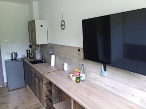 a large television on a wooden counter in a kitchen at Ferienhaus hERZgebirge in Bockau