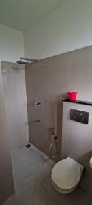 a small bathroom with a toilet and a sink at Botaniqs in Cochin