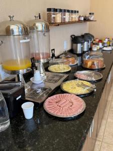 a kitchen counter with some food and a mixer at Bravo City Hotel Birigui in Birigui +11 photos