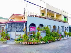 a building with potted plants on the side of it at Precious Ruby's Apartment in Manila