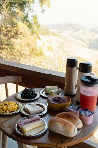 a wooden table with various types of food on it at Pousada Santosha in Camanducaia +40 photos