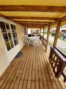 a wooden deck with a table and chairs on it at Camping Paradiso - Aranciona 7 in Viareggio