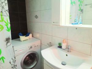a bathroom with a washing machine and a sink at Faros studios Kalymnos Lighthouse in Kalymnos