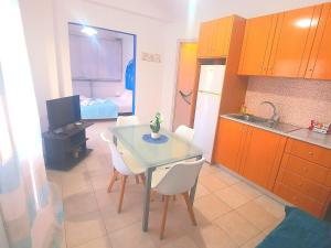 a kitchen with a table and chairs and a bedroom at Faros studios Kalymnos Lighthouse in Kalymnos