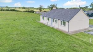 an aerial view of a small white building in a field at 3 Bed in Kerry oc-g32088 in Shrone