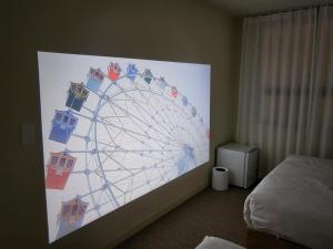 a large ferris wheel on the wall of a bedroom at Jeonju Hotel Book and Type in Jeonju +253 photos