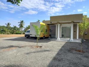 a yellow truck parked in front of a building at Onera Hotel & restaurant in Mahiyangana +5 photos