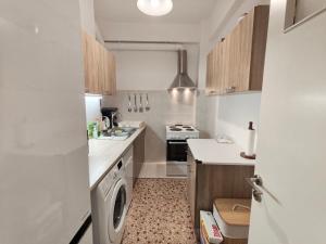 a small kitchen with a sink and a stove at Freatida apartment in Piraeus