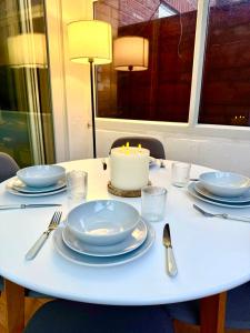 a white table with a candle on top of it at Stockport Stays in Stockport