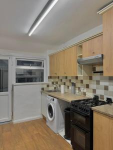 a kitchen with a washing machine and a washer at Stockport Stays in Stockport