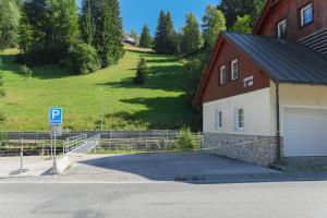 a parking lot in front of a building with a parking garage at Apartmány Lékařský dům in Pec pod Sněžkou +19 photos
