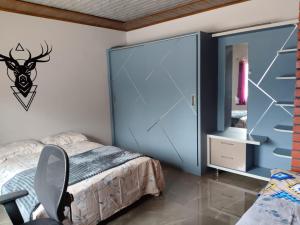 a bedroom with a bed with a large glass door at Achar homestay in Sringeri