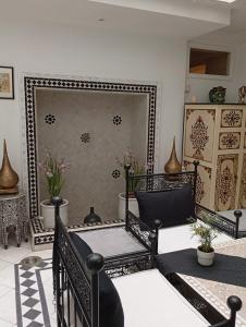 a living room with a mirror and a chair at Ryad Ayad in Marrakech