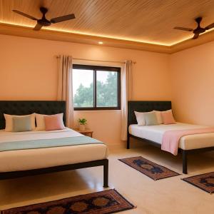 a bedroom with two beds and a window at Tulsi Villa in Panchgani