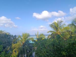 a view of the ocean and palm trees at Portia beach grand 2 in Male City