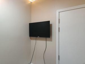 a flat screen tv hanging on a wall at Portia beach grand 2 in Male City