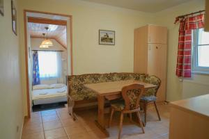a living room with a table and a couch at Apartmány Lékařský dům in Pec pod Sněžkou +19 photos