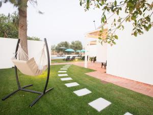 a hammock on the grass next to a patio at Tavira Monte in Tavira