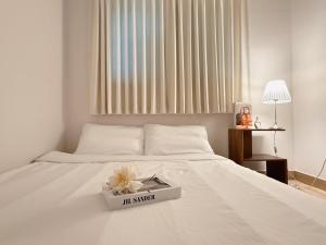 a white bed with a book on top of it at Ansik in Busan