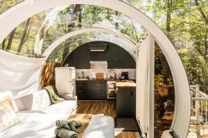 an arched kitchen and living room in a tent at Sunken Escapes #3 Kit's Retreat in New Minas +60 photos