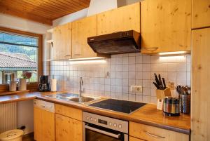 a kitchen with a sink and a stove at Apart Mia in Grossried