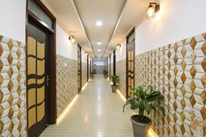 a corridor of a building with plants in a hallway at FabHotel Black Stone Palace in Ghaziabad