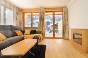 a living room with a couch and a table at Superb 3 room next to the chairlift in Arêches in Arêches